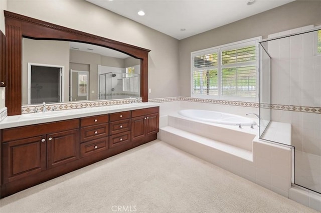 bathroom featuring a stall shower, a sink, carpet floors, double vanity, and a bath