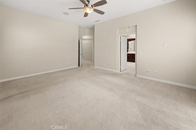 unfurnished room with baseboards, light carpet, visible vents, and a ceiling fan