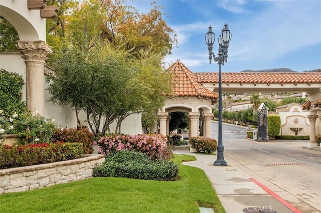 mediterranean / spanish-style house featuring a tile roof and stucco siding