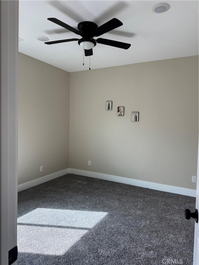 carpeted empty room with baseboards and ceiling fan