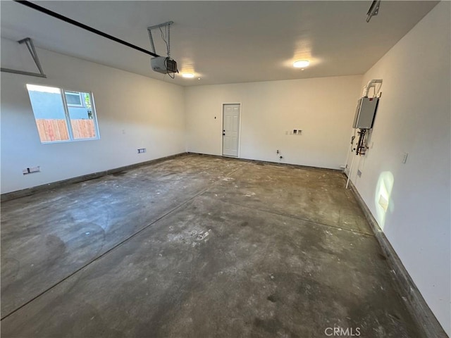 garage featuring a garage door opener and baseboards