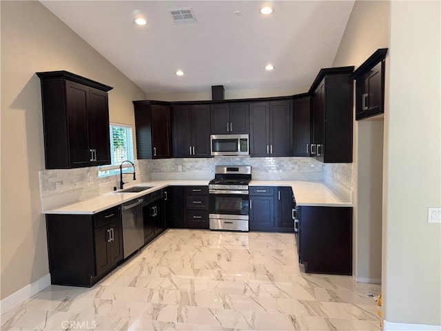 kitchen featuring visible vents, marble finish floor, a sink, stainless steel appliances, and light countertops