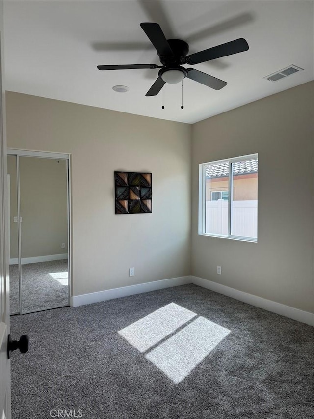 unfurnished bedroom with visible vents, carpet floors, baseboards, and ceiling fan