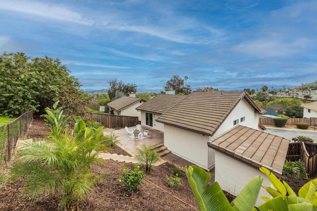 view of home's exterior featuring stucco siding, a tile roof, and a fenced backyard