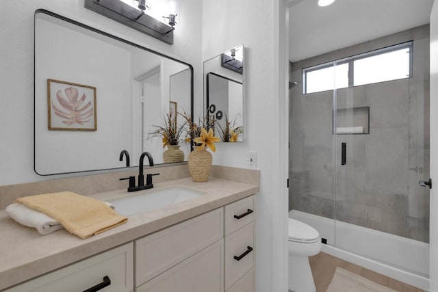 bathroom with a stall shower, toilet, and vanity