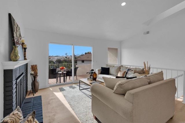 living area with recessed lighting and a fireplace