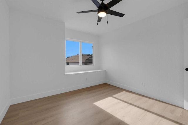 unfurnished room featuring ceiling fan, baseboards, and wood finished floors