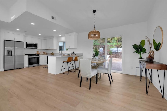 dining area featuring light wood-style flooring, recessed lighting, and visible vents