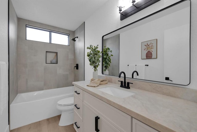 bathroom with shower / bathtub combination, toilet, vanity, and wood finished floors