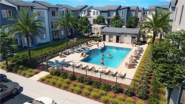 pool featuring a patio area, fence, and a residential view