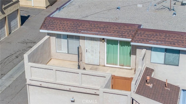 exterior details with roof with shingles