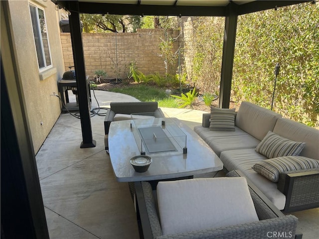 view of patio with grilling area, outdoor lounge area, and fence