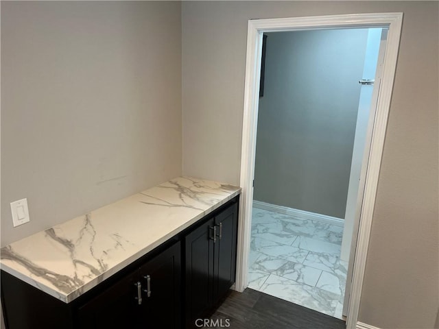 bathroom with marble finish floor and baseboards