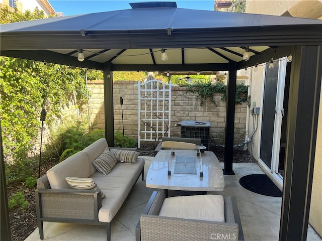 view of patio / terrace featuring a gazebo, cooling unit, an outdoor hangout area, and fence