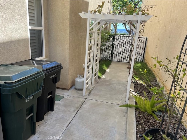 view of patio with fence and a pergola