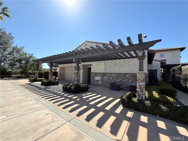 view of patio featuring central AC unit and a pergola