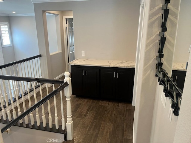 hallway featuring dark wood-type flooring and ornamental molding