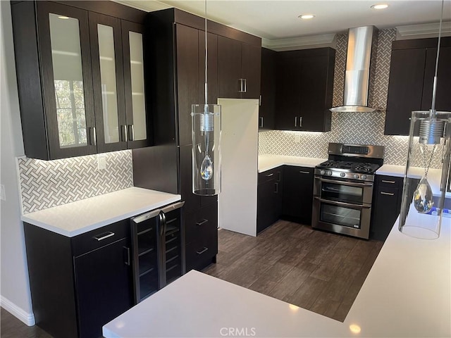 kitchen featuring dark wood finished floors, wine cooler, light countertops, range with two ovens, and wall chimney exhaust hood