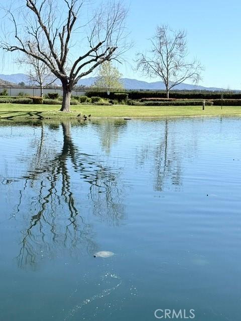 water view featuring a mountain view and fence