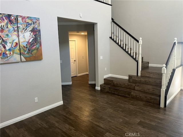 stairway featuring wood finished floors and baseboards