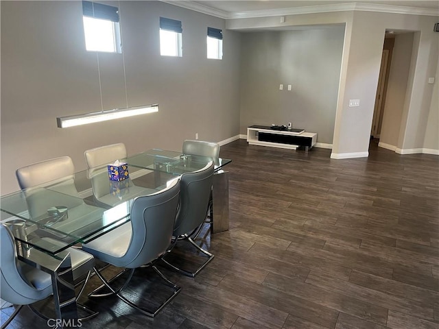 dining space featuring dark wood finished floors, baseboards, and ornamental molding