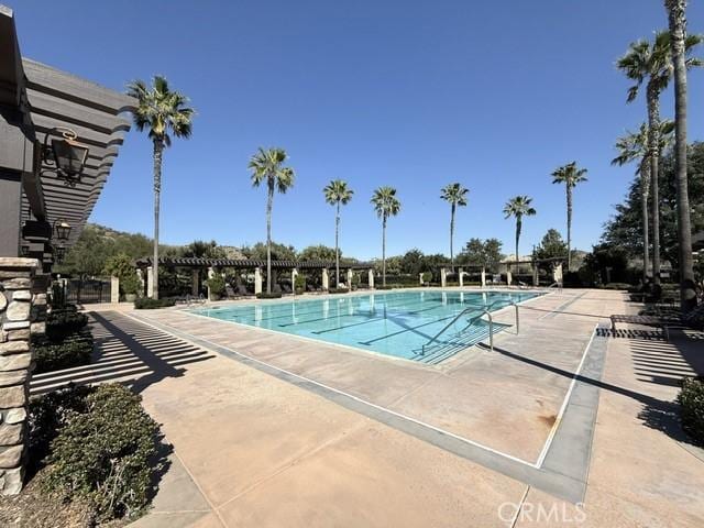 community pool featuring a patio area