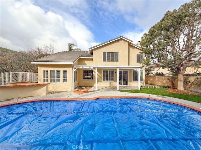 view of pool featuring a fenced in pool, a fire pit, fence, and a patio area