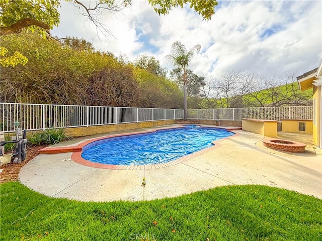 view of swimming pool featuring a patio, a fire pit, a fenced in pool, and a fenced backyard