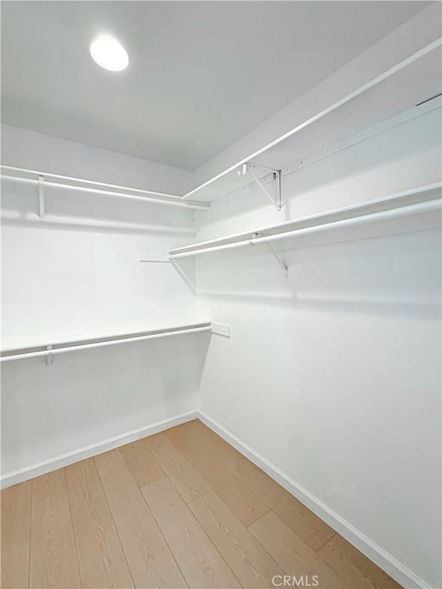 spacious closet with wood finished floors