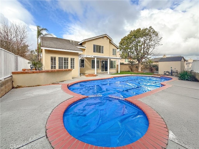 view of swimming pool with a patio, a fenced backyard, a fenced in pool, and an outdoor structure