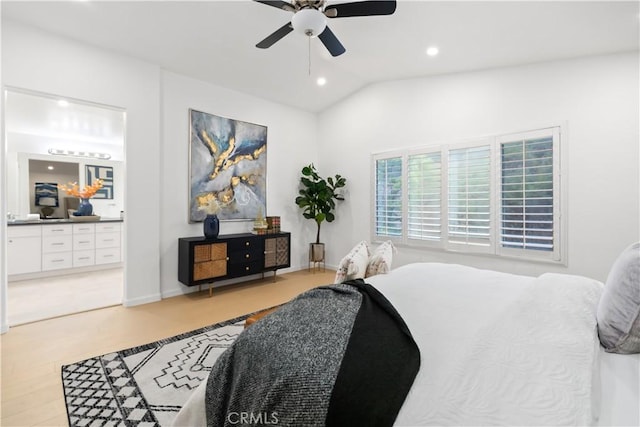 bedroom featuring light wood finished floors, ceiling fan, vaulted ceiling, recessed lighting, and ensuite bathroom