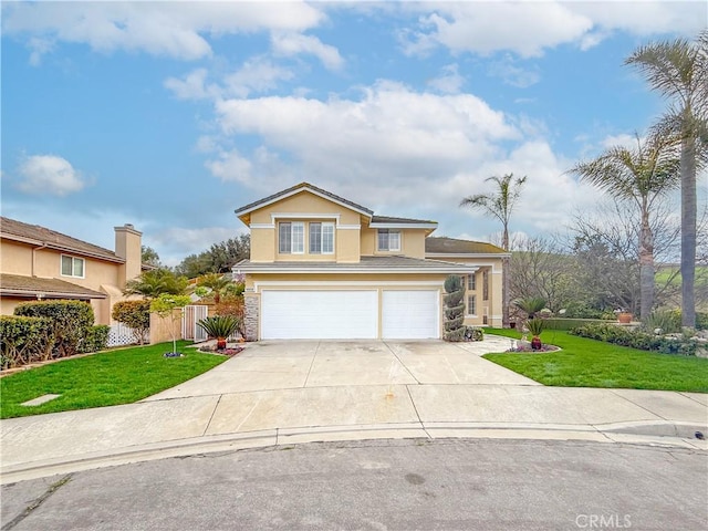 traditional-style home with a front yard, concrete driveway, a garage, and stucco siding