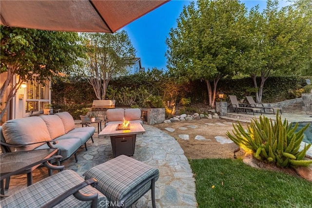 view of patio / terrace featuring an outdoor living space with a fire pit