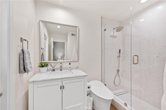 bathroom with vanity, visible vents, recessed lighting, a stall shower, and toilet