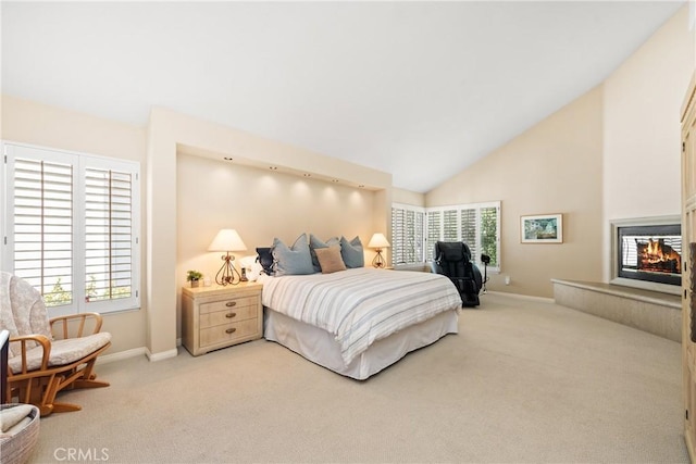 carpeted bedroom featuring baseboards, a multi sided fireplace, and high vaulted ceiling