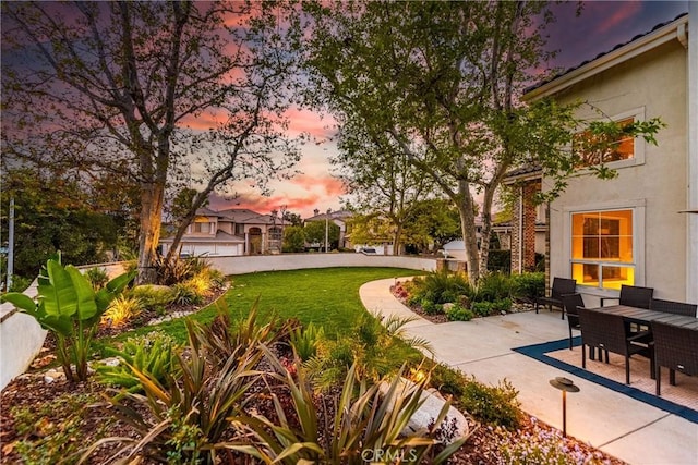 yard at dusk with a patio