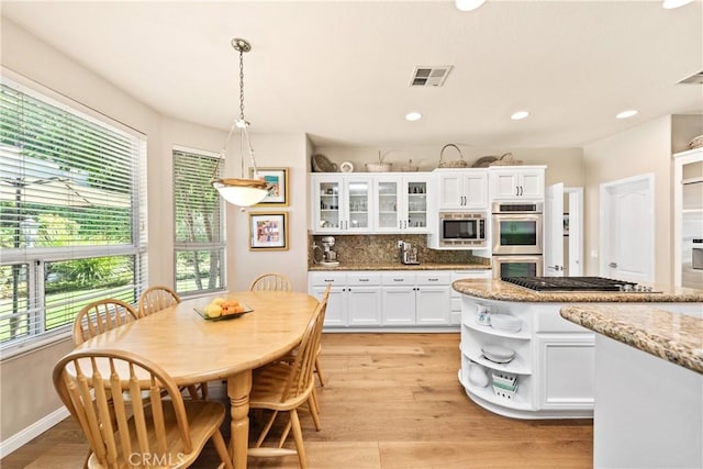 kitchen with open shelves, stainless steel appliances, visible vents, and white cabinetry