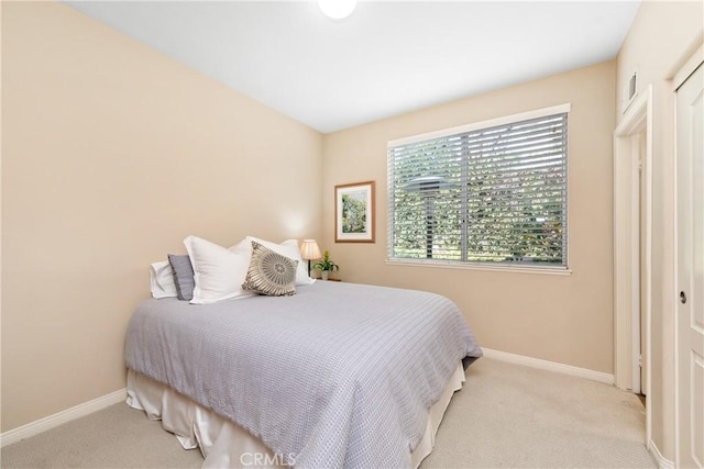 bedroom featuring carpet flooring and baseboards