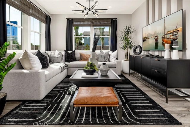 living area with a chandelier and wood finished floors