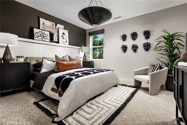 carpeted bedroom featuring visible vents and baseboards