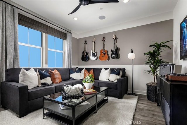 living room with baseboards, ceiling fan, and wood finished floors