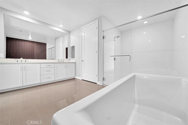 bathroom with a sink, an enclosed shower, recessed lighting, and double vanity