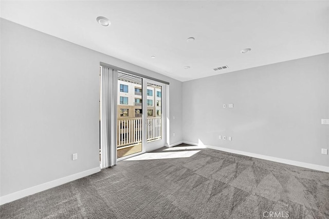 carpeted empty room featuring visible vents and baseboards