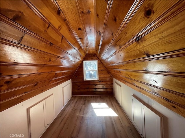 additional living space featuring lofted ceiling, wood finished floors, wood ceiling, and wood walls