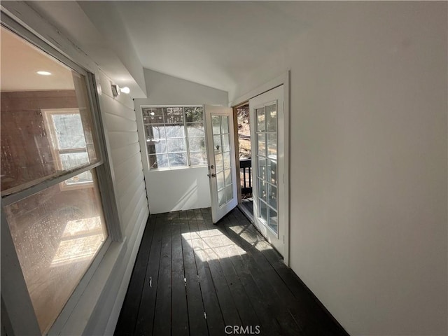 entryway with dark wood-style floors and vaulted ceiling