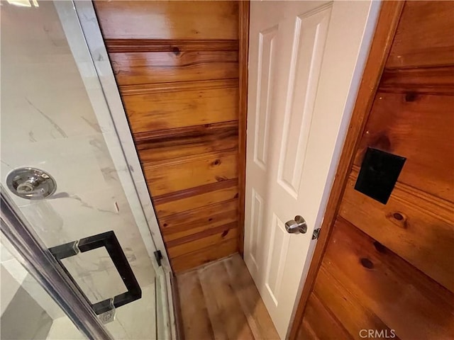 full bathroom with a shower stall and wood finished floors