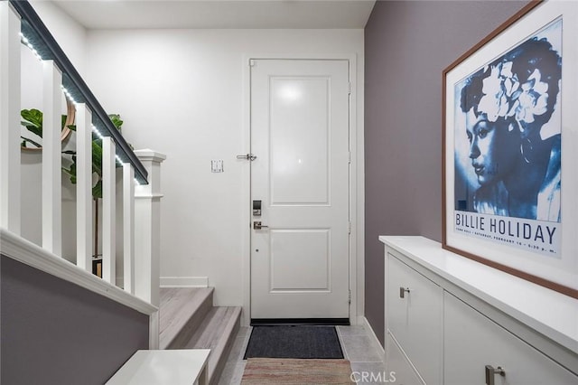 doorway to outside with light tile patterned floors and stairs