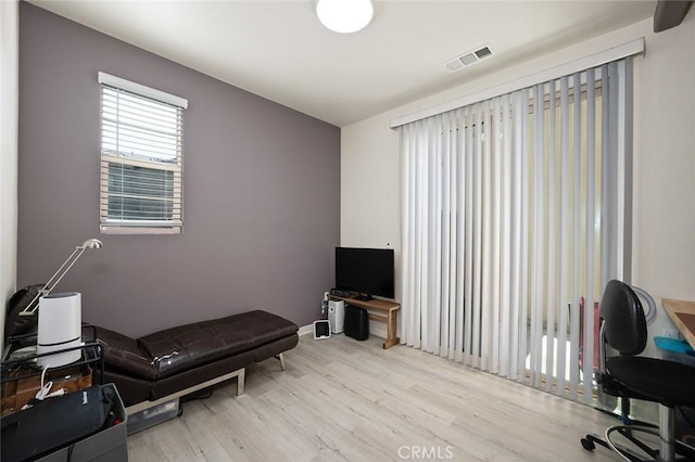 office area with visible vents and wood finished floors