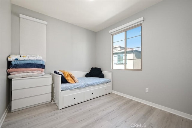 bedroom featuring baseboards and wood finished floors