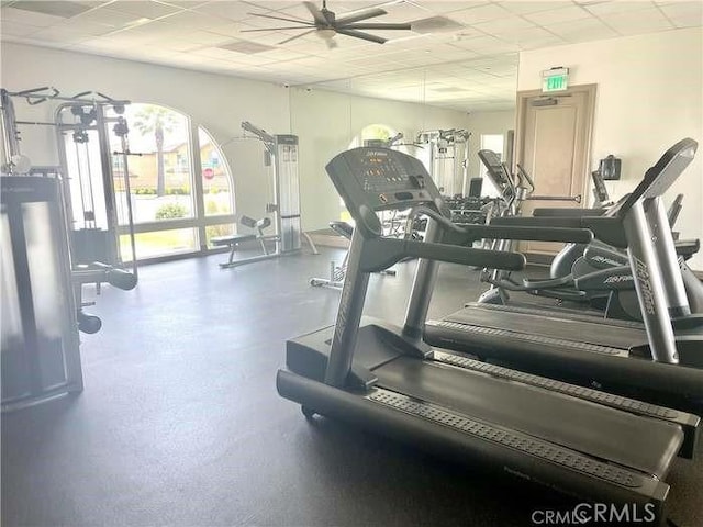 exercise room featuring a paneled ceiling and ceiling fan